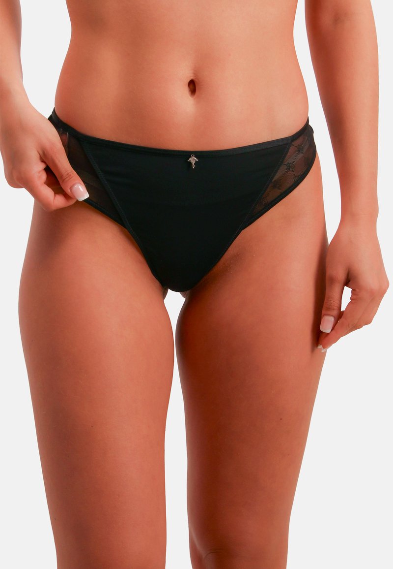 Black bikini bottom made of smooth fabric with mesh side panels. Features a small decorative accent at the front. Classic brief shape.