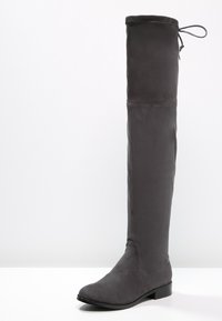 Knee-high gray fabric boot with a smooth texture, round toe, and flat sole. Features a lace detail at the top for adjustable fit.