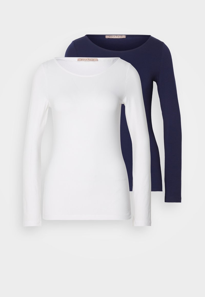Deux t-shirts à manches longues en blanc et bleu marine. Les deux ont un col rond, une texture lisse et un design ajusté pour le confort.
