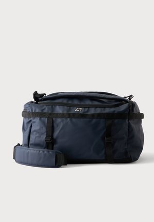 Sac polochon bleu marine avec bretelles noires, bandoulière rembourrée et poche zippée sur le dessus, sur fond blanc.