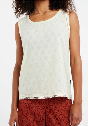 Haut sans manches couleur crème avec un motif en losanges texturé, doté d'une bordure en dentelle à l'ourlet. Le tissu semble léger et respirant.