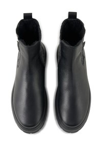 Bottines en cuir noir avec une finition texturée, dotées d'une doublure en laine grise douce, d'une semelle en caoutchouc plate et d'une languette au talon.