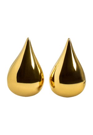 Dwa błyszczące, złote obiekty w kształcie kropli łzy o gładkich, refleksyjnych powierzchniach na białym tle.