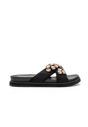 Black slide sandal with crisscross mesh straps adorned with large amber-colored gems and small studs around the sole.