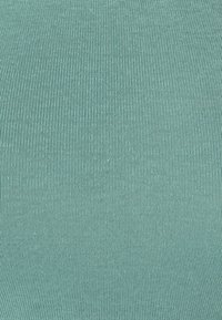 Ribbed fabric in soft teal color, featuring a consistent texture with vertical lines, creating a smooth, contoured appearance.