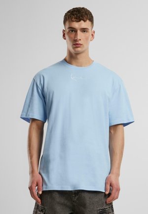 Light blue cotton t-shirt with a relaxed fit, short sleeves, round neckline, and white embroidered logo on the chest.