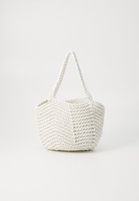 Woven white tote bag in a rounded shape, featuring two short handles and a textured surface with a pattern of interwoven włókien.