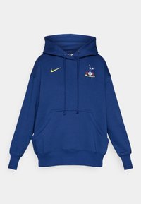 Námornícka modrá mikina s kapucňou vyrobená zo 100% bavlny, s prednou kapsou a žltým logom Nike. Obsahuje vyšívaný tímový znak na hrudi.
