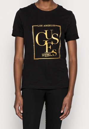 Zwart katoenen T-shirt met korte mouwen, voorzien van een gouden grafisch ontwerp met daarin "Los Angeles" en "est. 1981" binnen een rechthoekige rand.