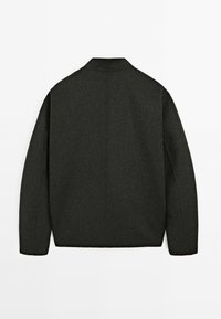 Dark gray wool blend jacket with a pointed collar, long sleeves, and a straight back design. Smooth texture and minimalist design.