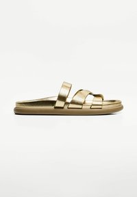 Gold metallic slide sandals with two cross straps and a rounded toe. Features a smooth surface and a flat, cushioned sole.