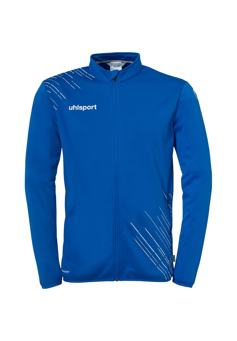 Blå sportsjakke med fuld lynlås, blødt materiale og hvide skrå linjer på venstre side; har uhlsport-logoet på brystet.