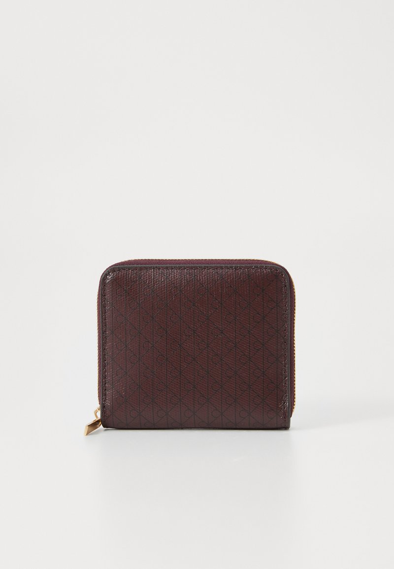 Burgundy zippered wallet with embossed diamond pattern and gold-tone hardware. Textured surface, compact rectangular shape.