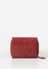 Red leather wallet with a textured finish, zip closure, and embossed logo on the front, featuring a circular pull tab for easy access.