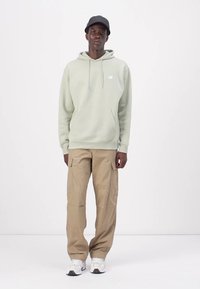 New Balance SPORT ESSENTIALS HOODIE UNISEX - Sweater - green