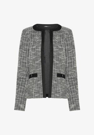 Chaqueta de tweed en blanco y negro con cuello redondo, apertura frontal, dos acentos negros en los bolsillos y un acabado texturizado.