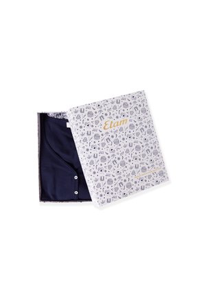 Navy blue garment inside a decorative white box with fun patterns. Box features “Etam” in gold. Button detail visible on the garment.
