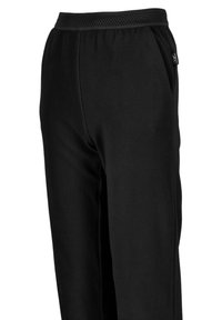 Pantaloni in pile neri con una texture morbida, vita elastica e tasche laterali. Presentano una vita traspirante e un discreto dettaglio con logo.