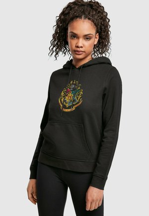 Black hoodie with a front pocket and drawstring hood. Features a colorful Hogwarts crest design on the chest. Made from soft fabric.