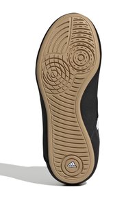 Svart skosula med texturerat gummi, med ett cirkulärt mönster och kanter. Adidas-logotypen präglad på hälområdet.