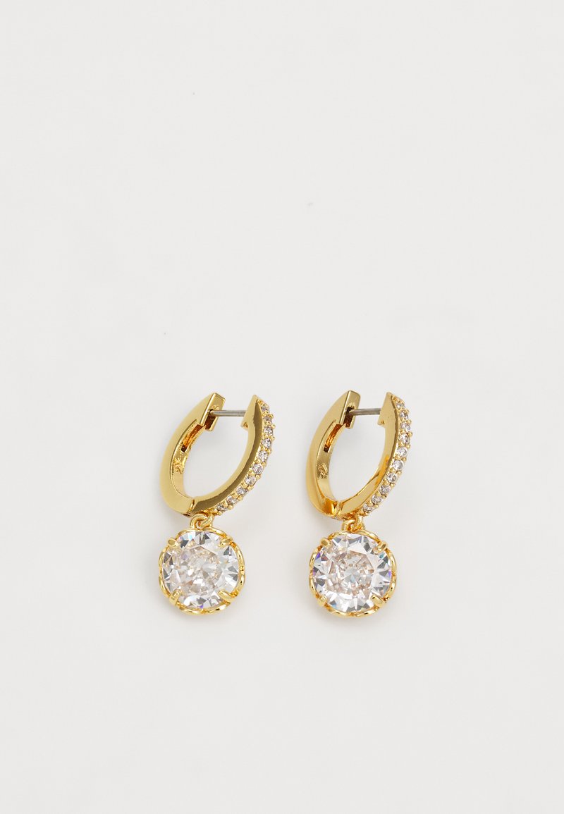 Gold hoop earrings with a textured design, featuring a round clear gem suspended at the base, accented by smaller clear stones along the hoop.