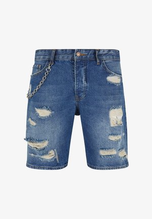 Denim shorts in medium blue with distressed rips and frayed edges. Features a silver chain detail attached to the front pocket.