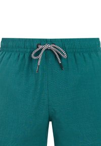 Shorts à taille élastique turquoise avec cordon noir et blanc en zigzag noué en un nœud à l'avant au centre.