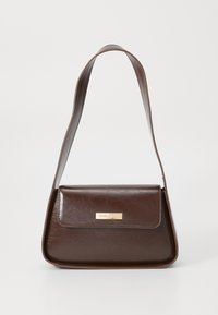 Brown leather shoulder bag with a structured shape, featuring a magnetic flap closure and a metallic logo accent on the front.