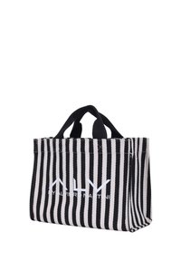 Borsa a spalla a righe in tessuto bianco e nero, con manici corti e logo visibile sul davanti. Forma rettangolare con base quadrata.