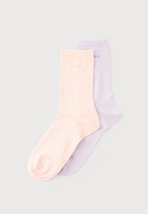 Pair of pastel-colored socks, one pale pink and one light lavender, laid flat on a light grey background.