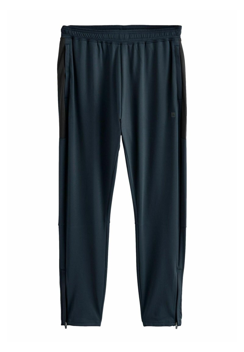 Pantalones deportivos azul oscuro con cintura elástica, bolsillos laterales con cremallera y detalles negros en los costados, fabricados en un tejido liso y elástico.