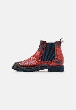 Red and dark brown crocodile-patterned leather ankle boot with navy elastic side panels and textured rubber sole, featuring a pull tab.