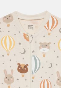 Body beige chiaro con motivi colorati di mongolfiere e animali, con dettagli di stelle e luna. Chiusura con zip completa sul davanti.