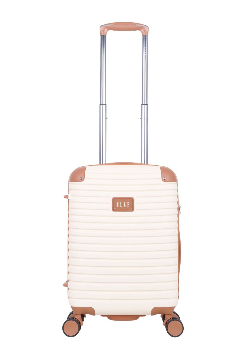 Cream hard-shell suitcase with ribbed texture, brown accents, retractable handle, and four wheels for mobility. Brand logo displayed prominently.