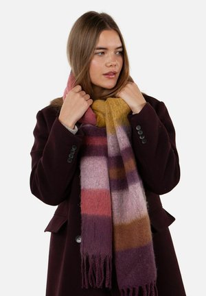 Wool scarf featuring pink, purple, and mustard stripes, with fringed edges. Worn loosely around the neck, styled with a dark coat.
