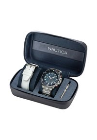 Set di orologi Nautica in una custodia nera e blu. Presenta un orologio in acciaio inossidabile argentato con quadrante blu, dettagli rossi e cinturino in pelle bianca. Include attrezzo.