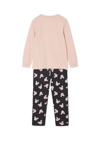 Pink long-sleeve top with round neck paired with black pants featuring repeated light pink Mickey Mouse pattern. Soft cotton fabric.