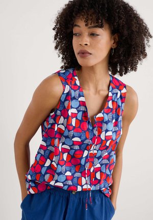 Sleeveless top featuring a vibrant pattern of red, blue, and white shapes on a navy background. Lightweight fabric with a relaxed fit.