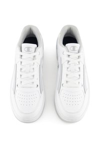 White sneakers made of leather with perforated toe, laces, and gray accents. Features a logo on the tongue and soft interior lining.