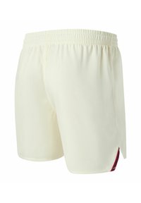 Pantaloncini color crema con tessuto strutturato, vita elastica e una striscia a contrasto rossa e blu navy sul lato.