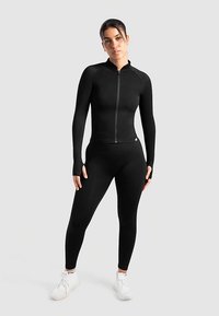 Black athletic set featuring a zip-up long-sleeve top and fitted leggings, made of stretchy fabric for comfort and movement.
