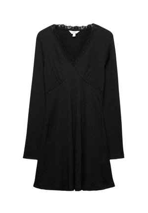 Vestido mini negro de manga larga con escote en V y ribete de encaje, cintura ajustada y tejido texturizado.