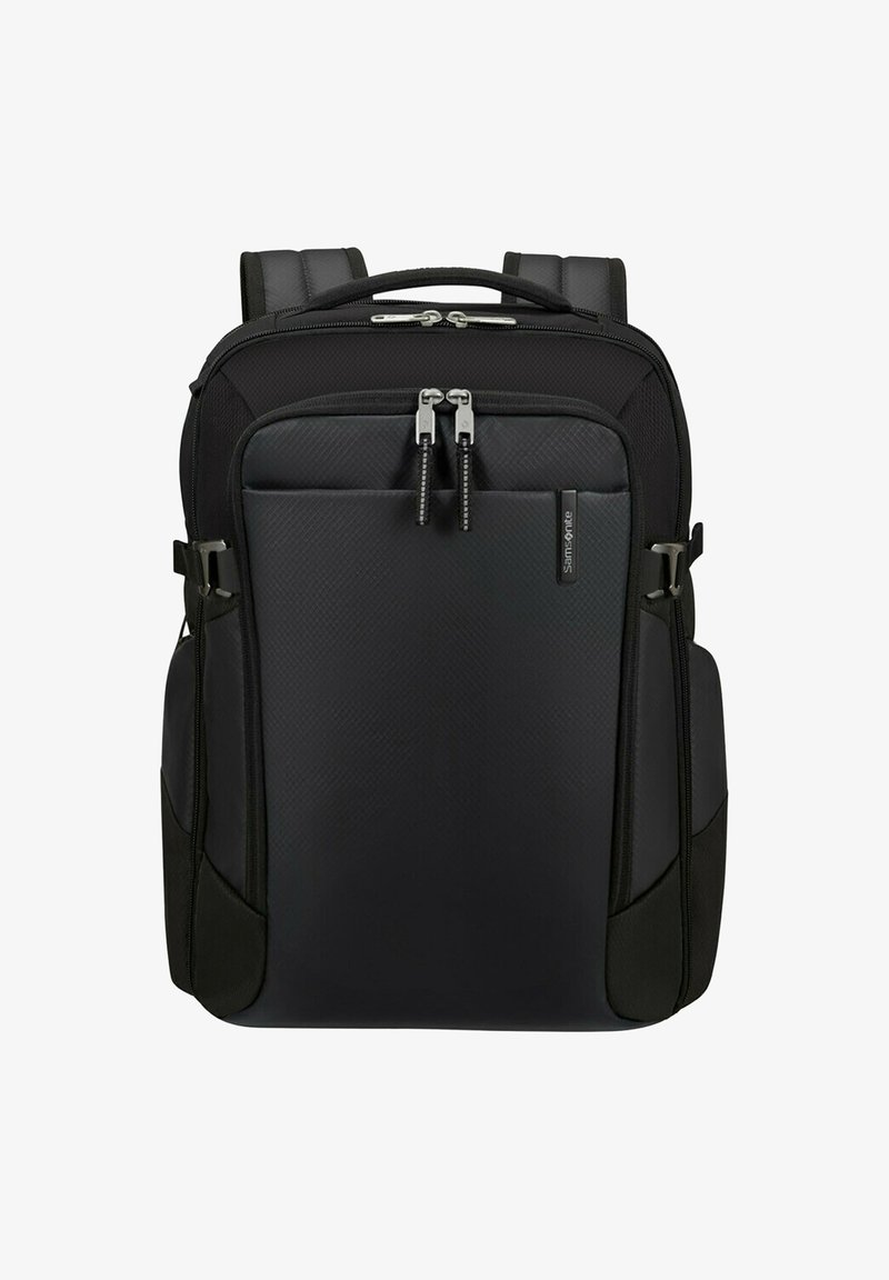 Mochila negra Samsonite con correas acolchadas, dos compartimentos principales con cremallera y bolsillos laterales, mostrada sobre un fondo blanco.