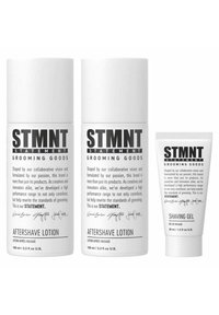 STMTN grooming goods set includes two white cylindrical aftershave lotion bottles and a small white tube of shaving gel, all labeled.