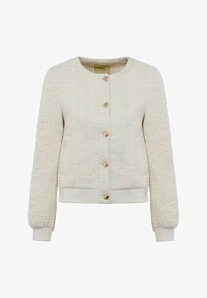 Kremowa kurtka z teksturowanej tkaniny, o okrągłym dekolcie, złotych guzikach i elastycznych mankietach. Posiada wzór tkany oraz prążkowany dół.