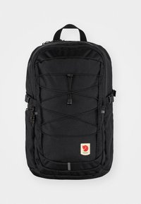 Black backpack with a durable fabric, featuring a bungee cord design at the front, side pockets, and a logo patch at the bottom.