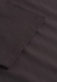 Dark brown cotton fabric with a smooth texture. Features a clean edge and subtle stitching detail along the hem.