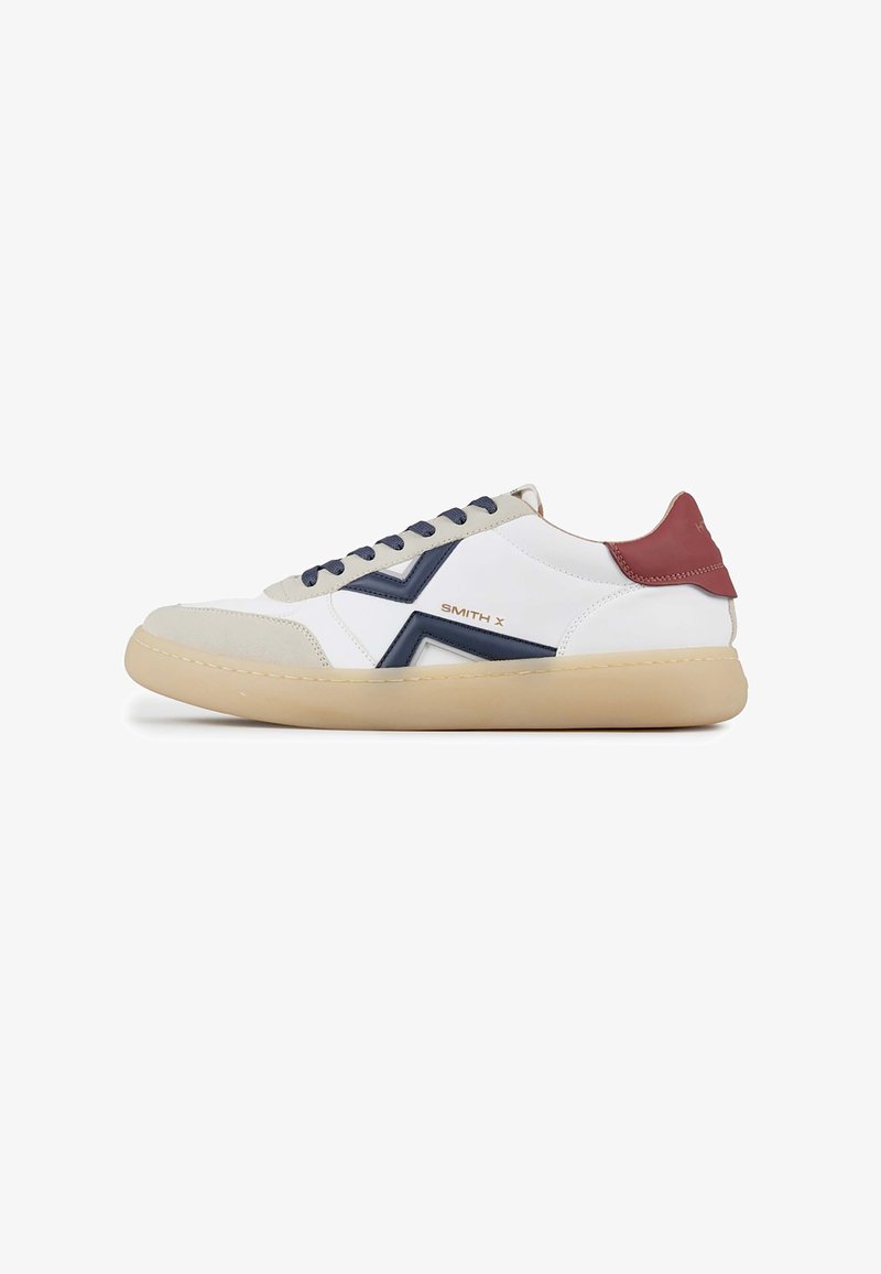 White leather sneakers featuring navy accents, light grey suede toe, and burgundy heel, with beige rubber sole and navy laces.