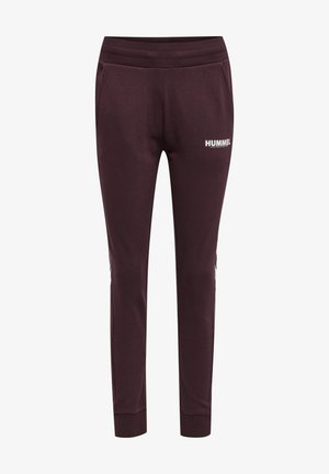Joggers slim couleur bordeaux foncé avec taille élastique, poches latérales, poignets aux chevilles côtelés et logo blanc « HUMMEL » sur la cuisse droite.