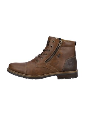 Bottes chelsea en cuir marron avec un bout rond, détail de fermeture éclair sur le côté, devant à lacets et couture contrastante. Semelle en caoutchouc plate.